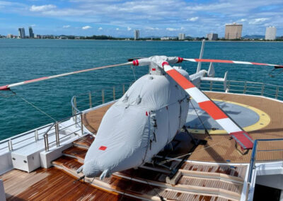 Bell 429 on a yacht, in the sun, with a full white protective cover set.