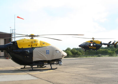 Metropolitan Police Airbus EC145 landing behind another EC145 with Air Covers cockpit and cabin covers