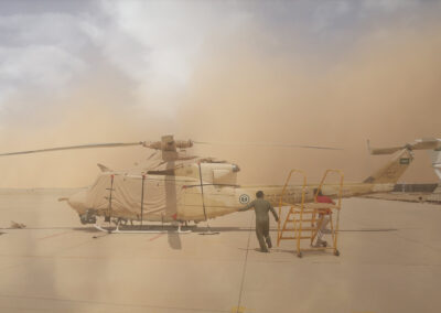 Bell 412 with a sand colour operational cover set in the midst of an approaching sandstorm.
